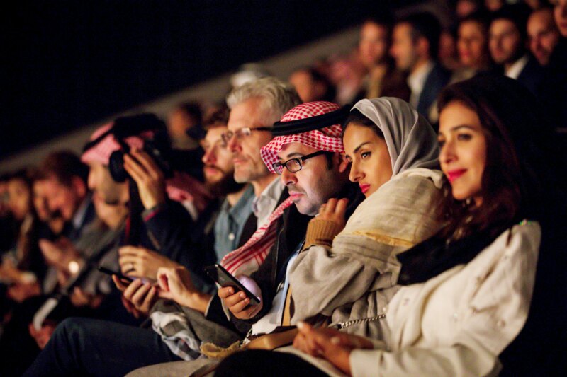 A large crowd waits to see an opera concert at the Maraya concert hall.