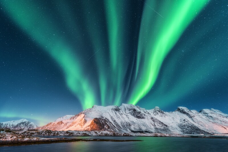 Green lights over mountains in Norway