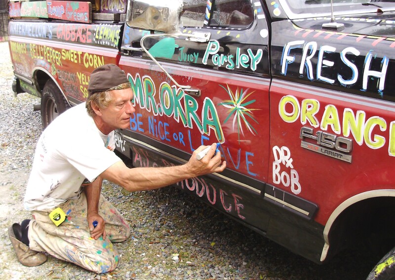 Dr. Bob painting the truck of another New Orleans icon‚ Mr. Okra, who sold produce from his polychromatic truck.