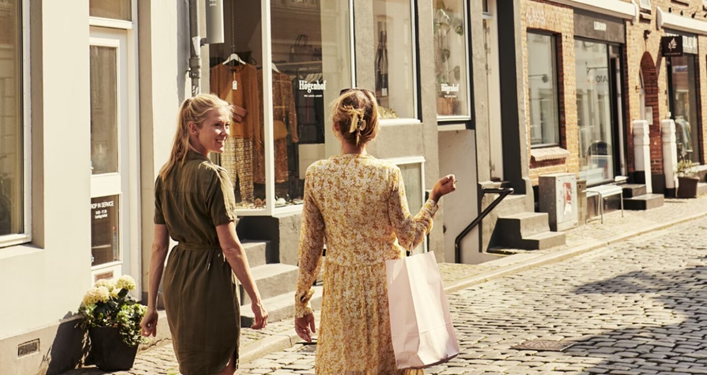 A couple walk through a shopping street