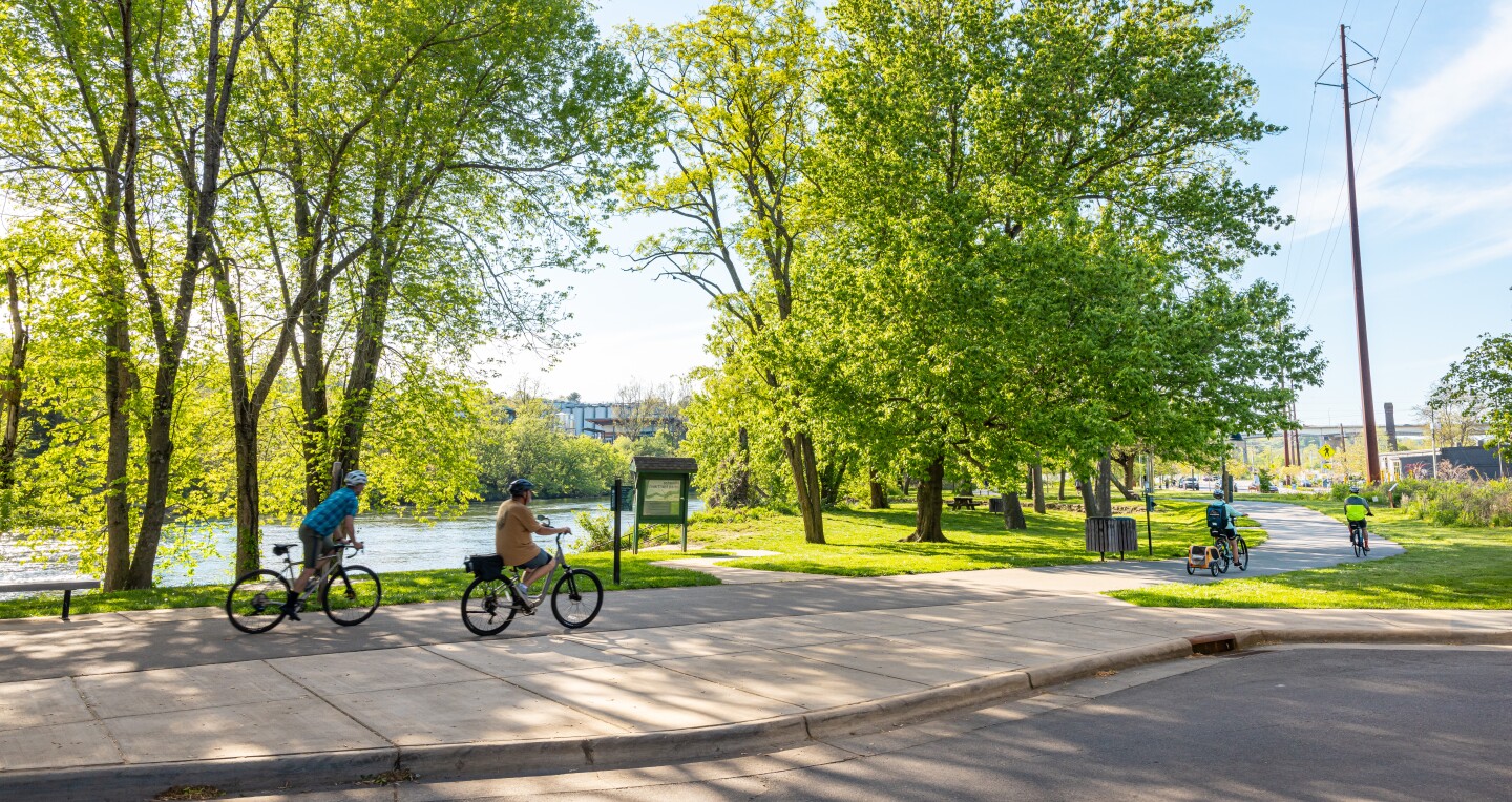 Two people cycling along the Asheville Greenway in Asheville, North Carolina