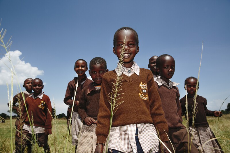 Children from a local school supported by Angama’s foundation pose for a photo.