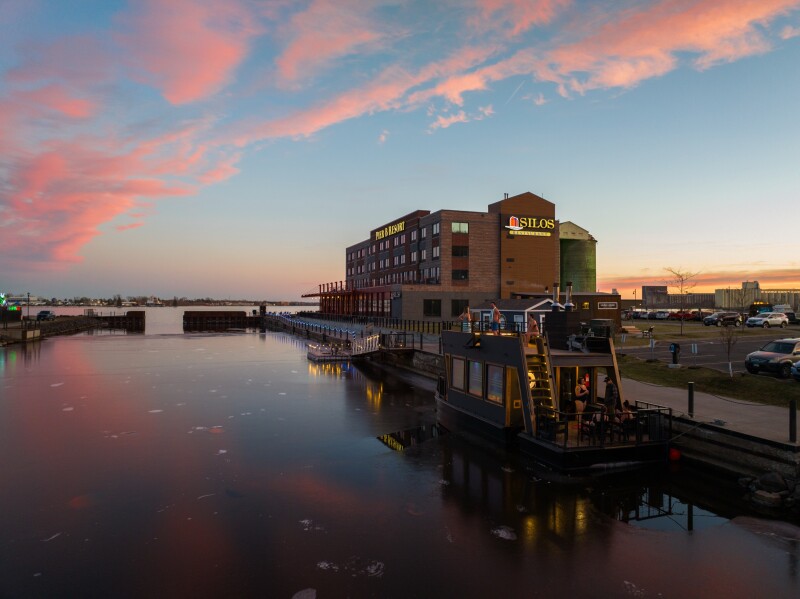 The exterior of Cedar and Stone Sauna on a pier at the edge of the water in In Duluth, Minnesota.