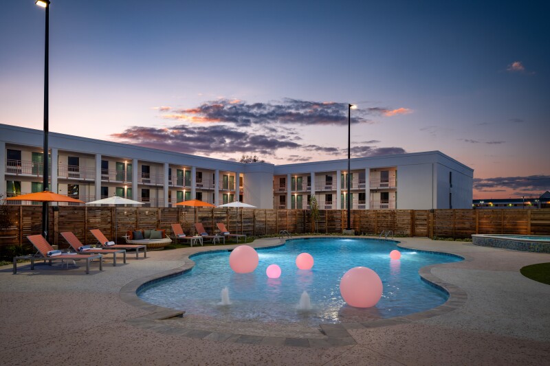 White building with pool in front