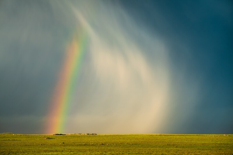 A rainbow forms as hail falls from the sky in Keota, Colorado, on June 21, 2018.