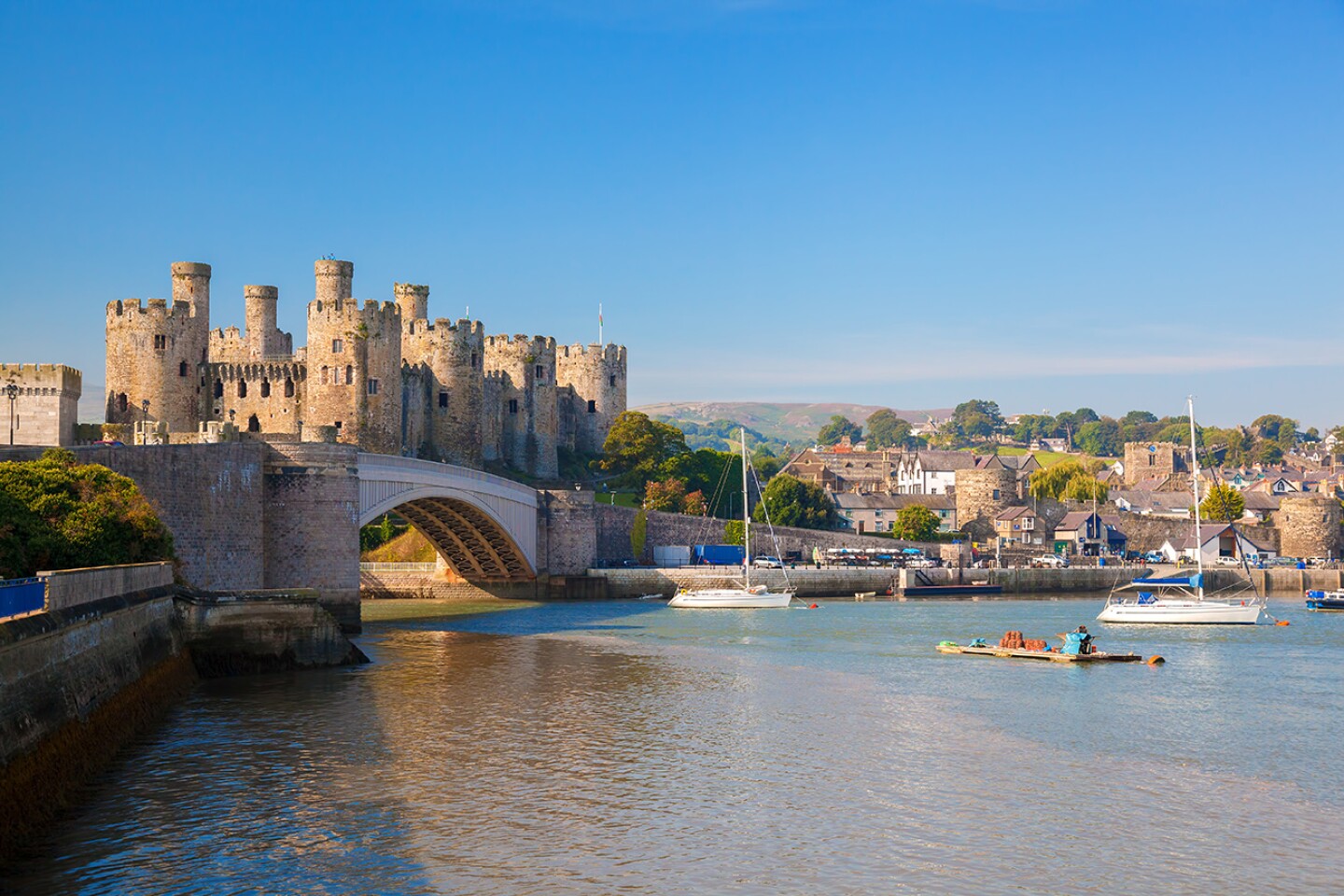 The Conwy Castle in Wales overlooks two rivers, the walled town of Conwy's harbor, and the surrounding mountains of Snowdonia.