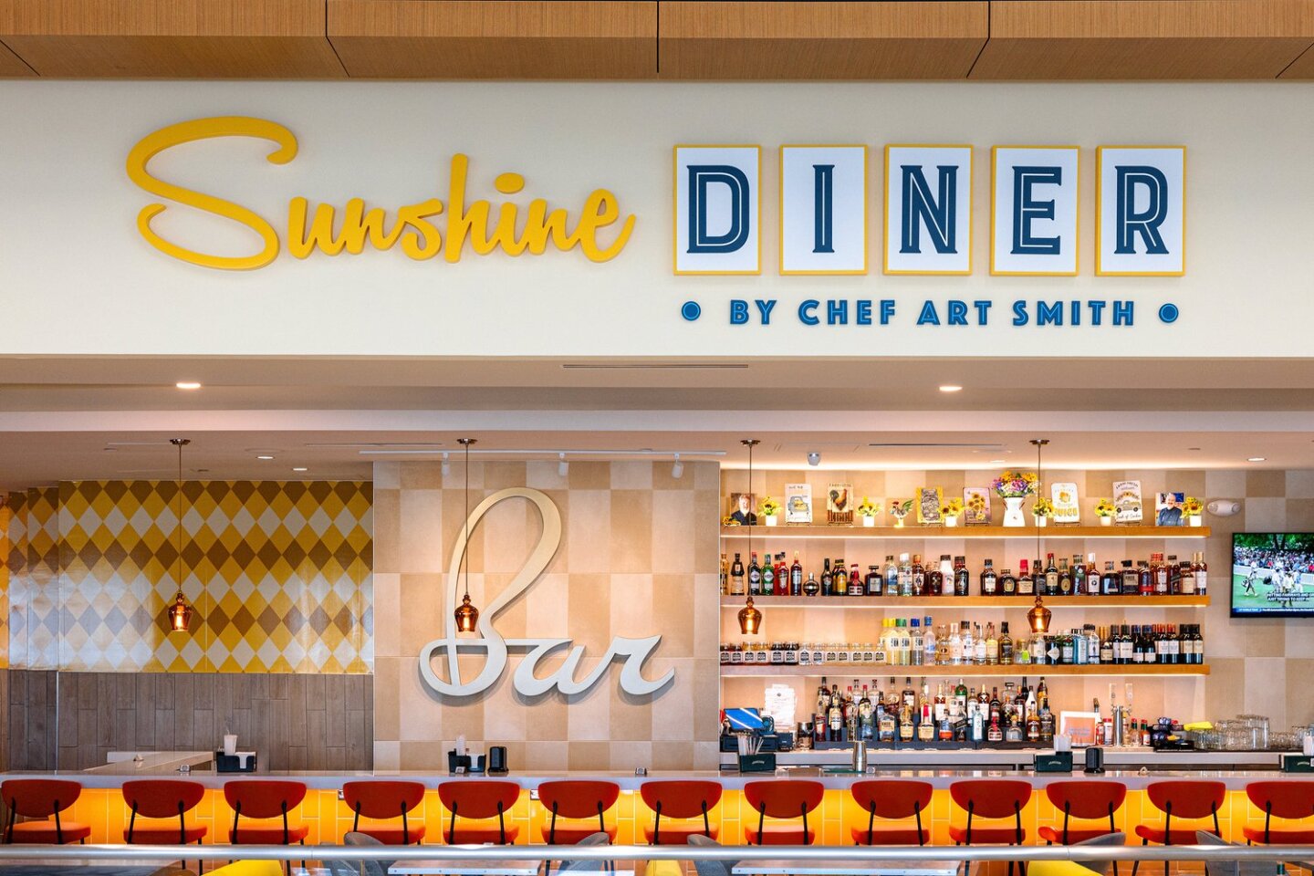 Empty bar with red seats at Sunshine Diner in Orlando airport's newly opened Terminal C