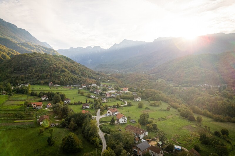 Aerial view of rural Bosnia and Herzegovina countryside, with a road and a few homes