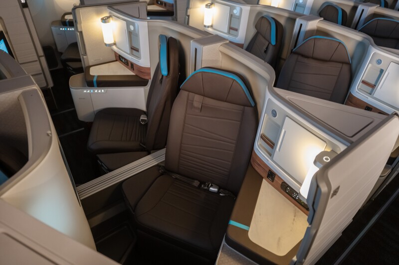 The pods include an 18-inch in-flight entertainment screen, personal outlets, and wireless charging.