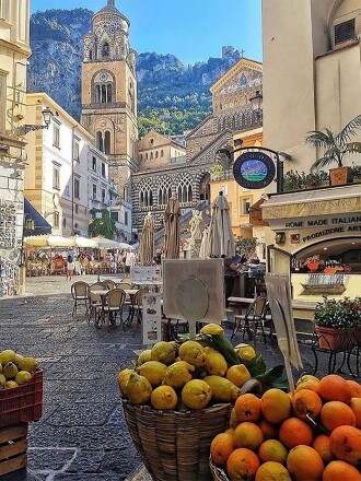 View of an Amalfi town square with fruits for sale in the foreground