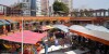 Peru, Lima, Miraflores, Malecon de la Reserva, Larcomar, shopping, dining, lifestyle center, centre, dining, luxury high-rise, building, awning, arcade, man, woman,.