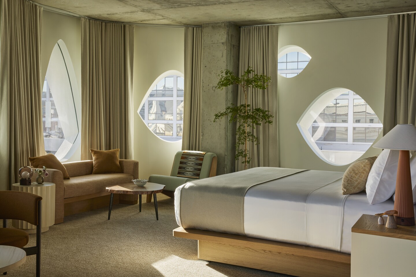 A Studio Suite at the Populus, with four eye-shaped windows and neutral hued interiors.