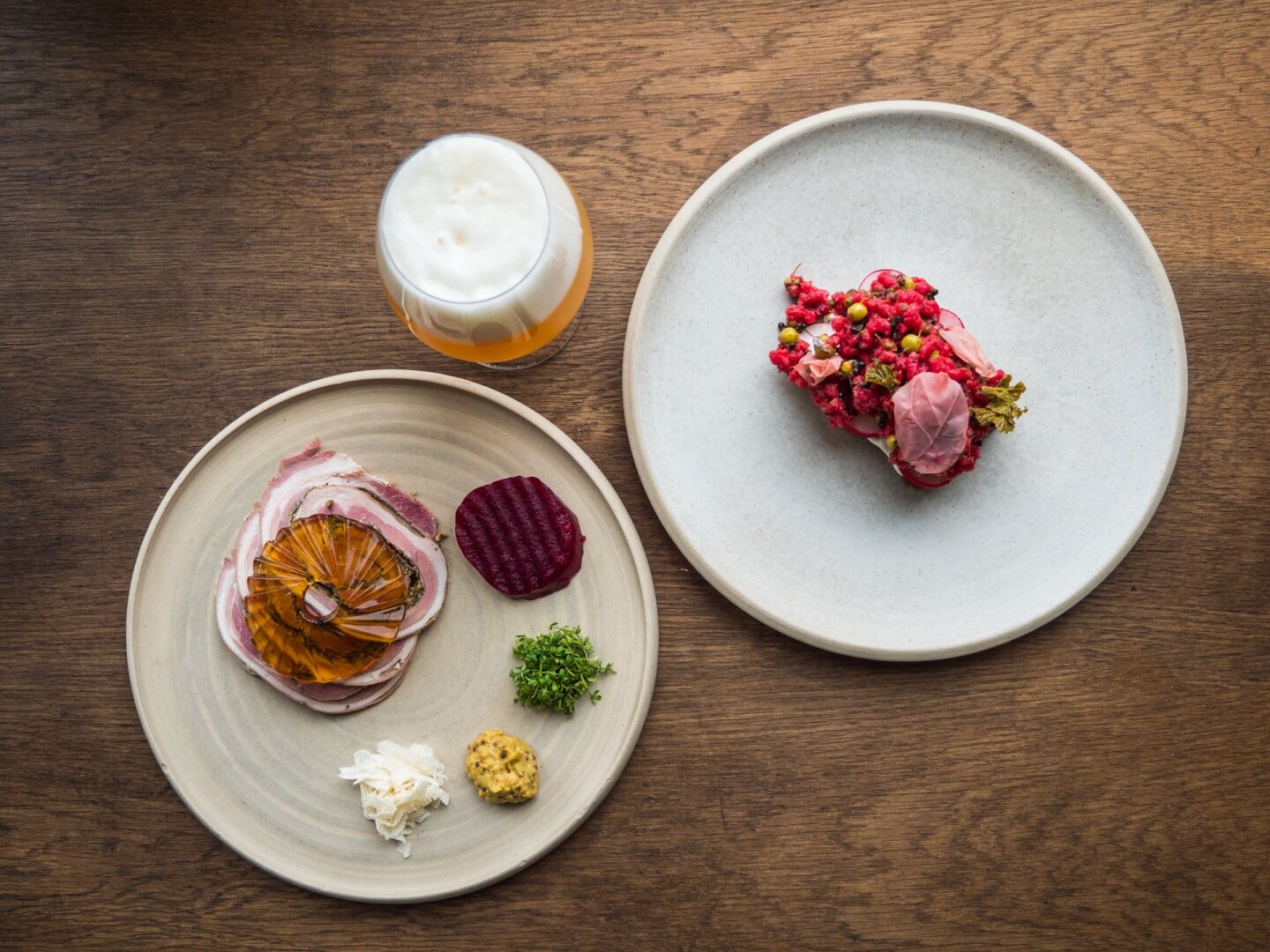 Minimalist plates of plant-based food on a table at Barr restaurant in Copenhagen, Denmark.