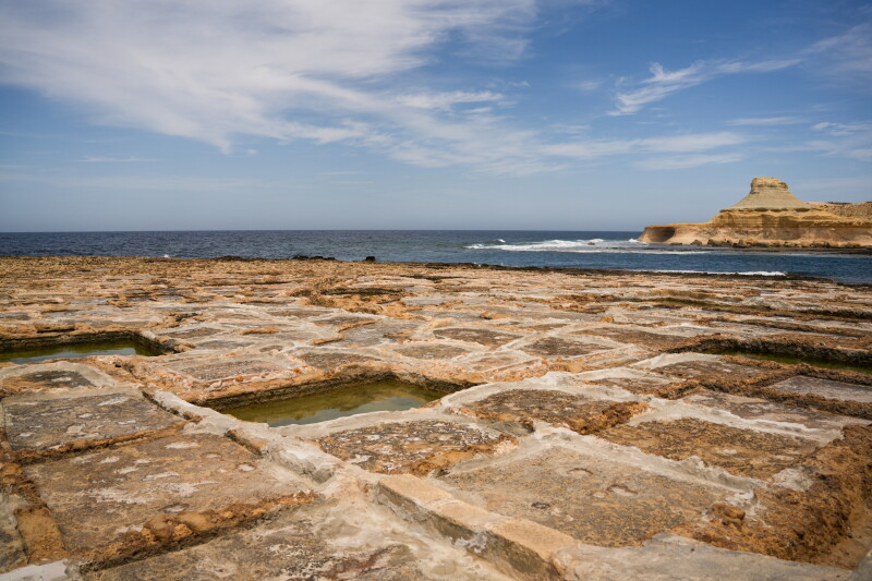 The sea salt beds at Xwejni form a grid-like pattern bordering the sea