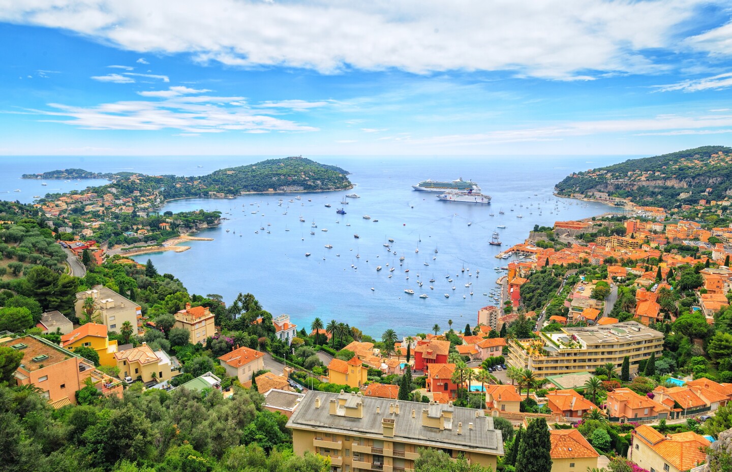 Overhead view of the bay in Nice, France, with buildings with orange-tiled roofs all around