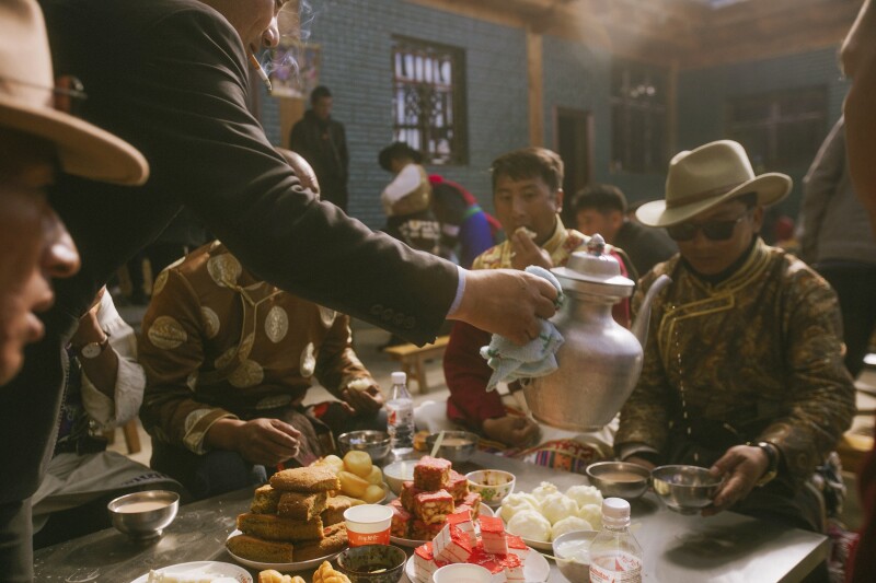 At a housewarming party in Shangri-La, guests sip yak butter tea and snack on pork buns and other local delicacies.