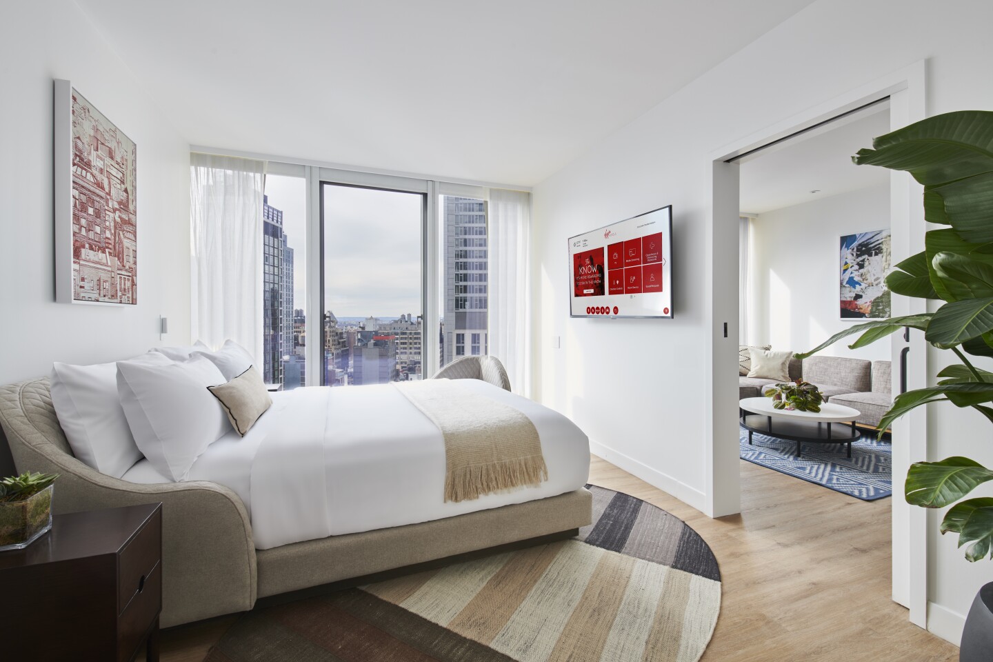 Interior of mostly white suite in Virgin Hotels New York