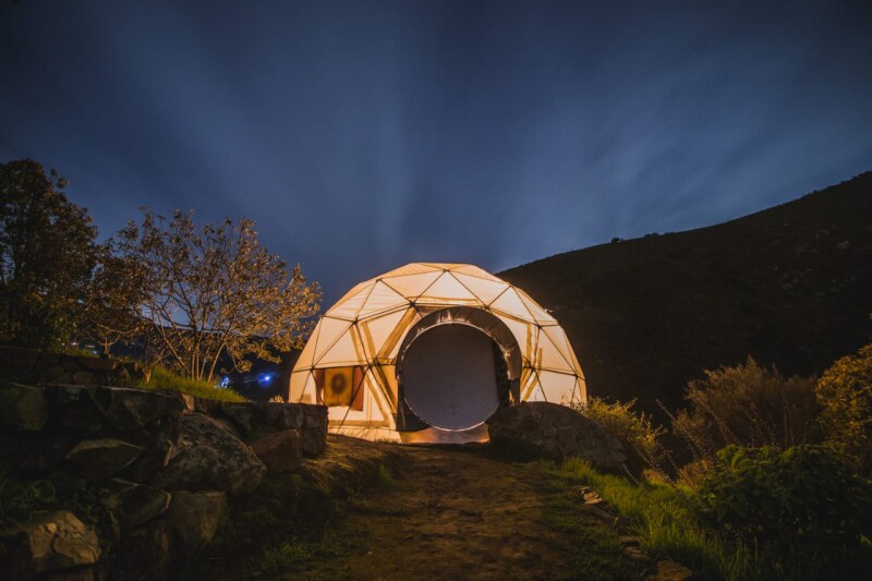 White geodesic dome Airbnb at night in the wilderness