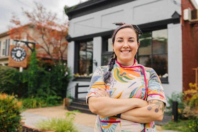 Kari Rushing, owner and executive chef of Vault & Cellar, standing outside restaurant in colorful top
