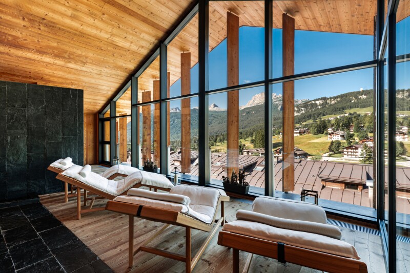 This lounge area at Hotel de Len is clad in wood and faces the Dolomite mountains.