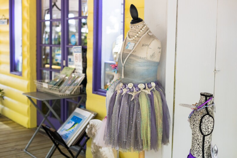 Fanciful costume dress on mannequin torso outside the Rain Barrel