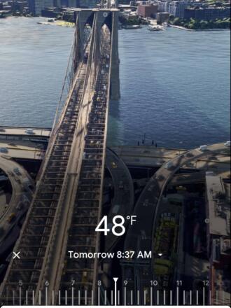 Google Maps screenshot of phone showing Immersive View of the Brooklyn Bridge over the East River in New York City. The screen has an overlay of the temperature outside, the time, and a slider so you can change the time and see views of the bridge at different times of day.