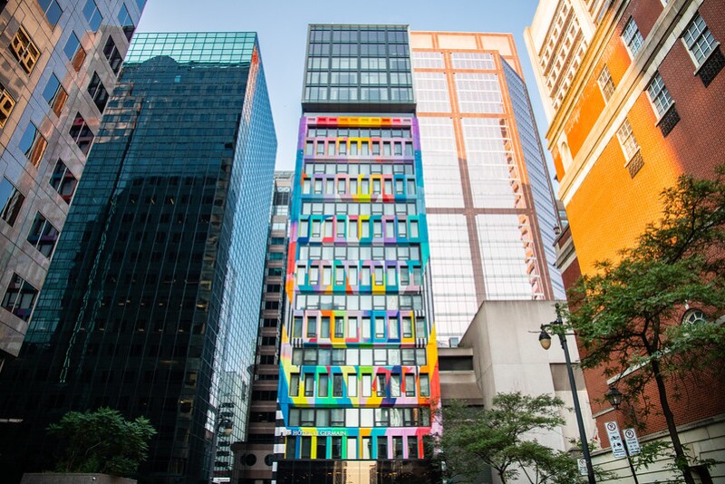 Hotel Le Germain's colorful facade stands out among the skyscrapers that surround it.