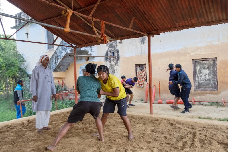 The girls are often encouraged to wrestle with boys during practice to build strength.