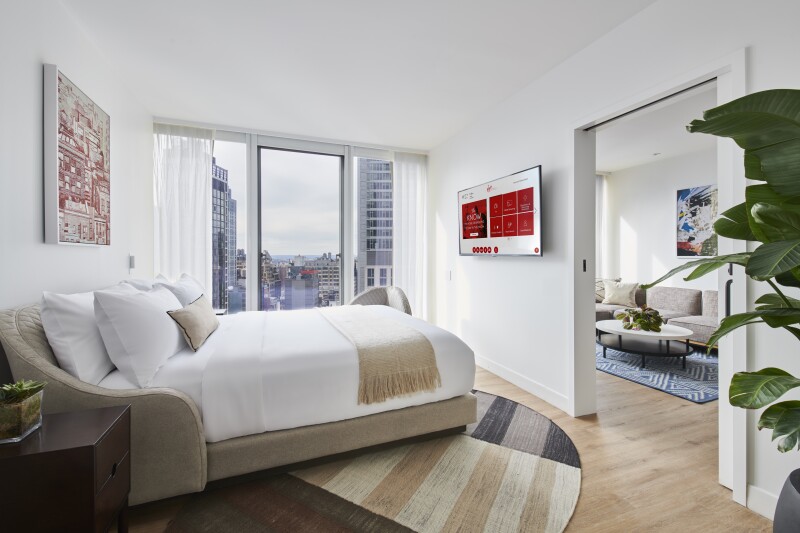 Interior of mostly white suite in Virgin Hotels New York