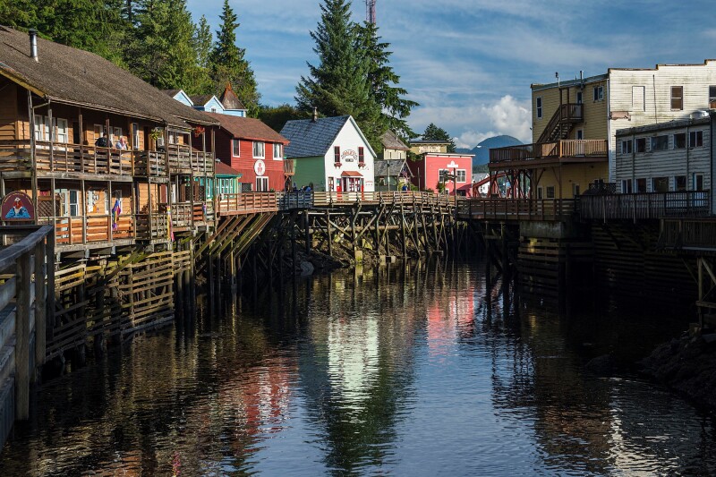 A row of houses on stilts over a boy of water in a small Alaskan town.