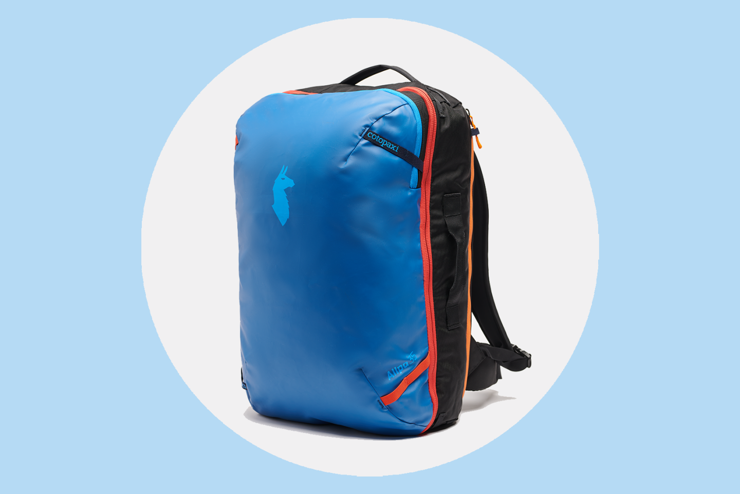 A dark blue Cotopaxi Allpa with laptop pocket open