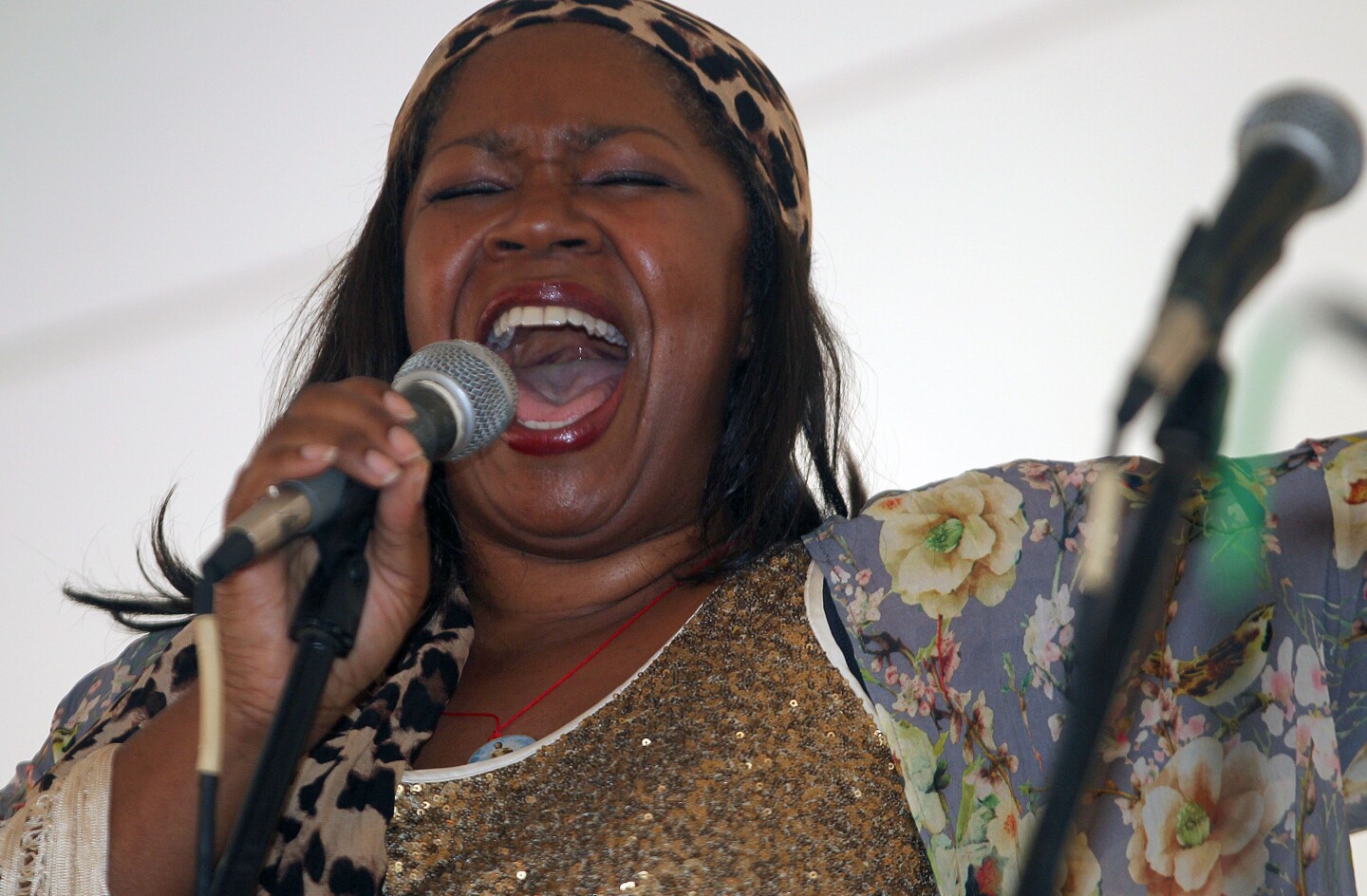 A woman singing into a microphone at the The Texas Jazz Festival in Corpus Christi