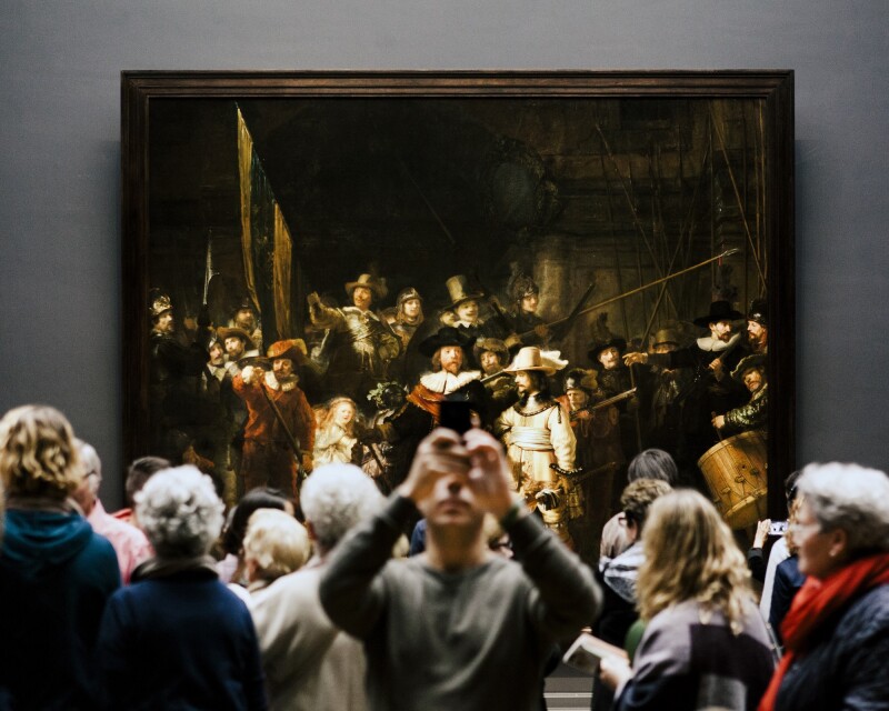 Onlookers gather in front of Rembrandt’s “The Night Watch” in Amsterdam’s Rijksmuseum.