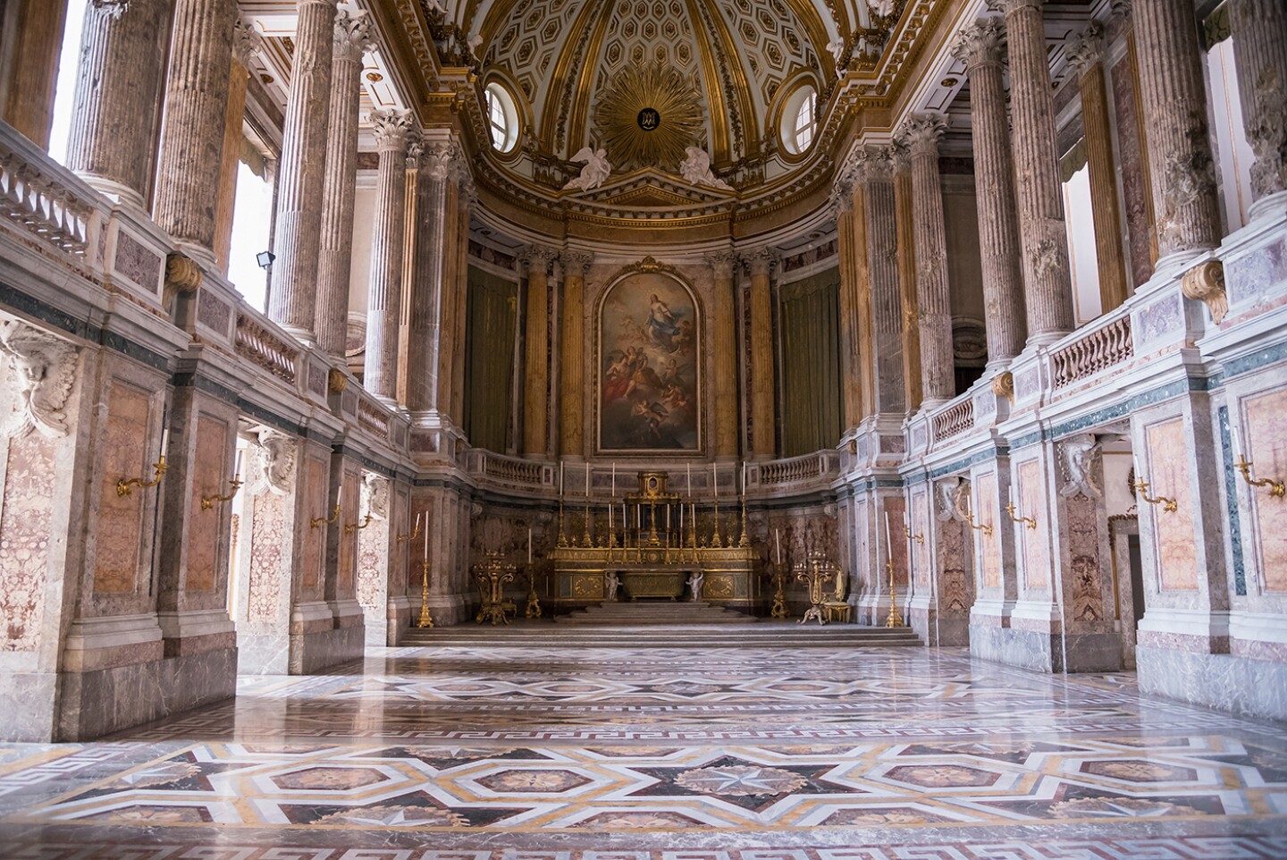 Interior of Royal Palace of Caserta, Italy, with columns and ornate marble floor
