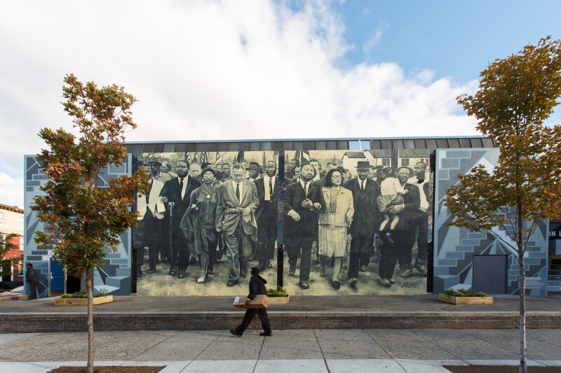 “Staircases and Mountaintops: Ascending Beyond the Dream” by Willis “Nomo” Humphrey is based on a 1965 photograph taken by William Lovelace.