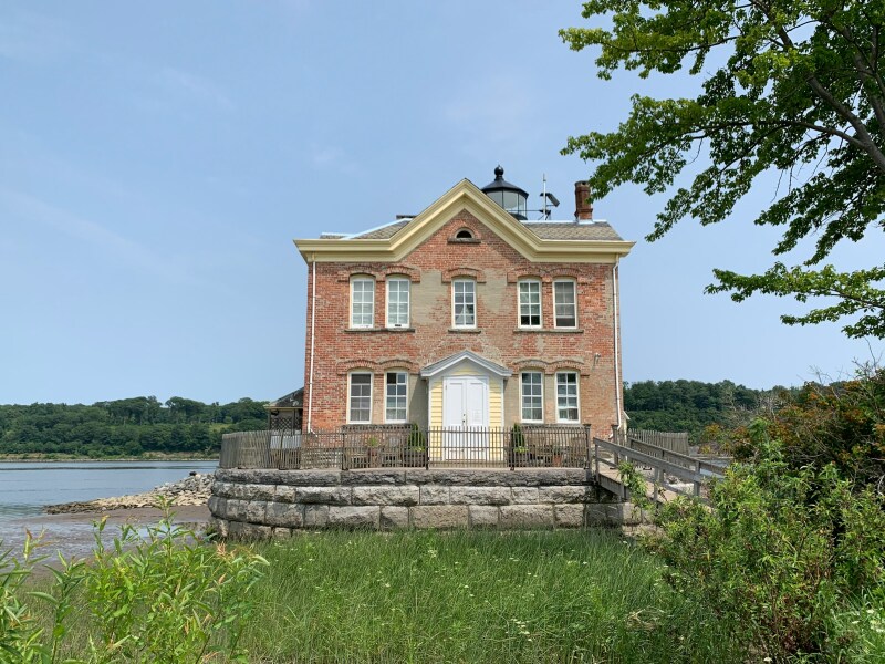 The front entrance of Saugerties Lighthouse in New York, a two-story brick building