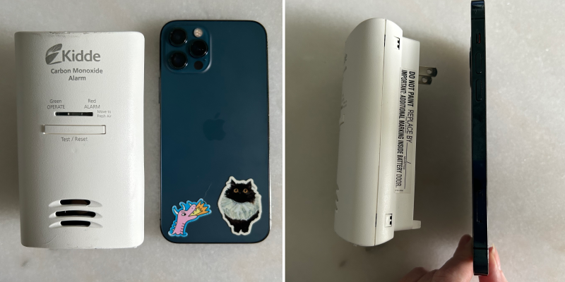 Travel carbon monoxide detector next to smartphone to show size