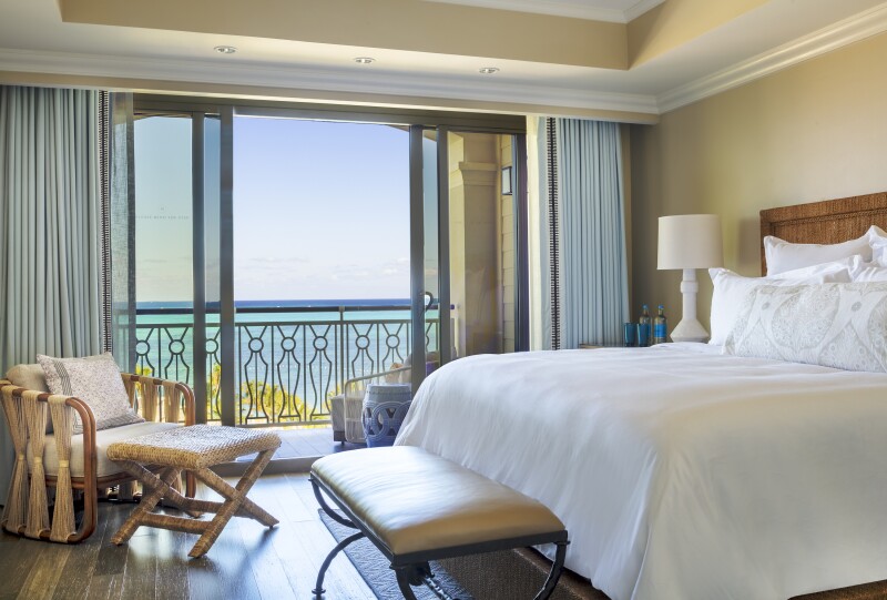 Guest room interior at Rosewood Baha Mar, with balcony overlooking water