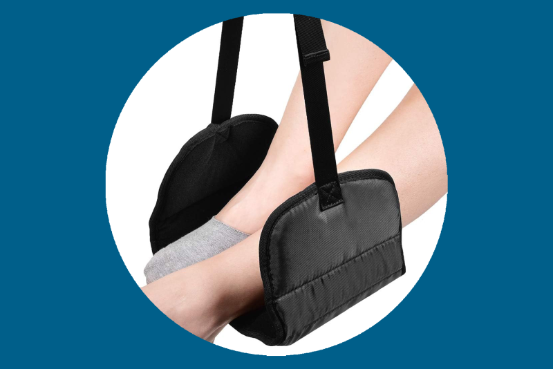 Black airplane footrest supporting two feet
