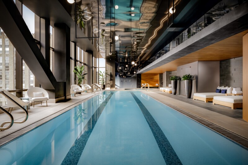The lap pool inside the Raffles Boston hotel is flanked by daybeds.