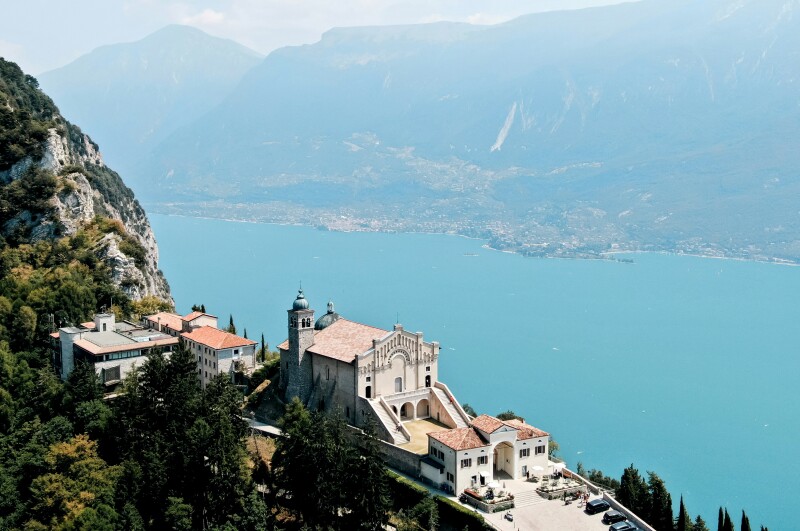 Aerial view of a hilltop building overlooking a lake.