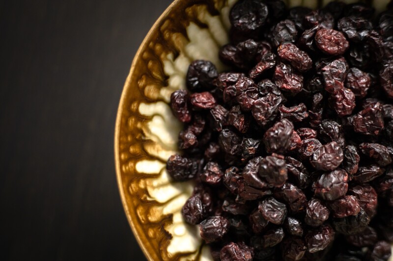 A bowl of dark raisins