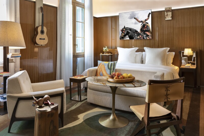 Interior of guest room at the Rosewood São Paulo, with warm woods and neutral hues in furnishings