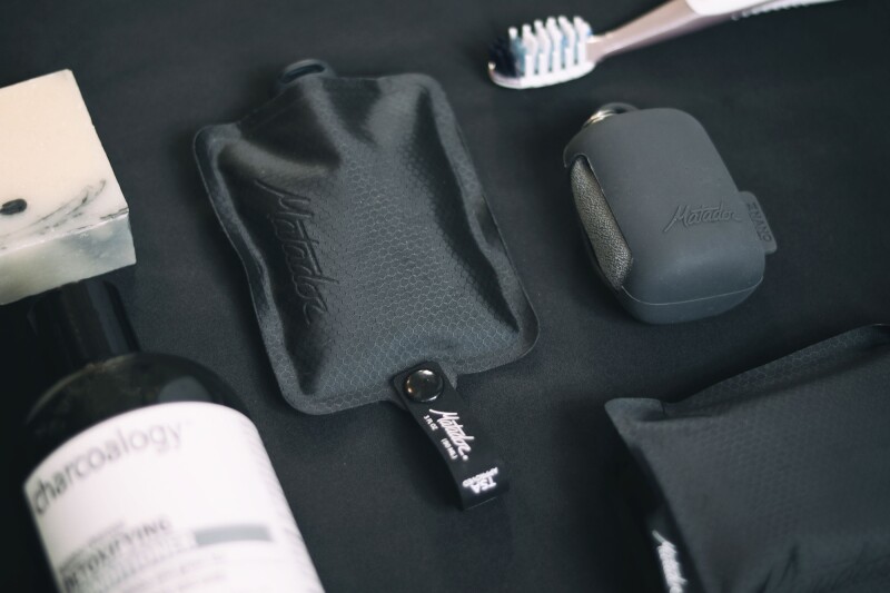 FlatPak bottle and soap bar holder among other toiletry kit items