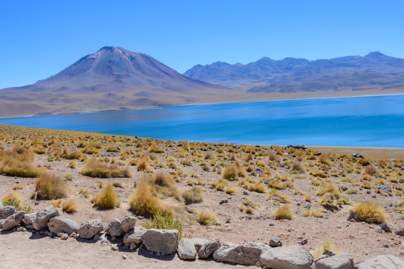 Lake with brown mountain behind it