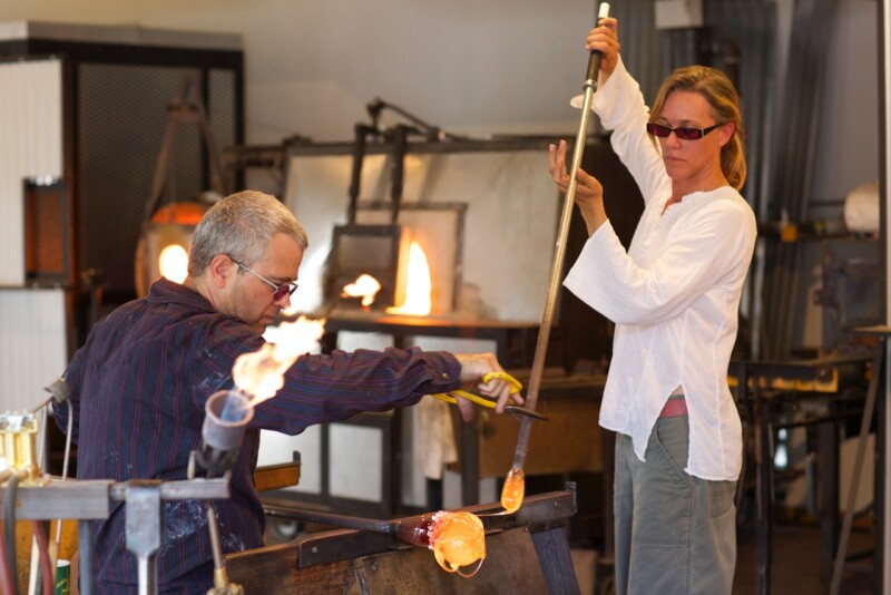Two glassblowers working at the North Rim Glass Studio in Crawford