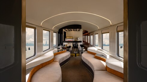 The lounge space on the Orient Express La Dolce Vita, featuring curvy benches and an espresso bar
