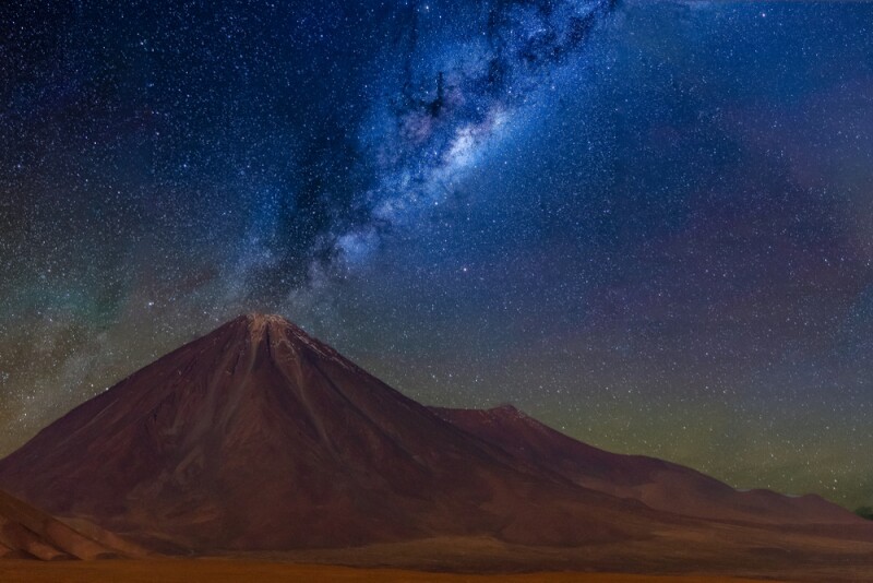 Blue galaxy above a desert mountain