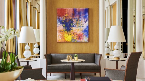 The Imperial Suite at the Park Hyatt Paris-Vendôme is decorated in neutral hues with colorful contemporary art in the center of the room.