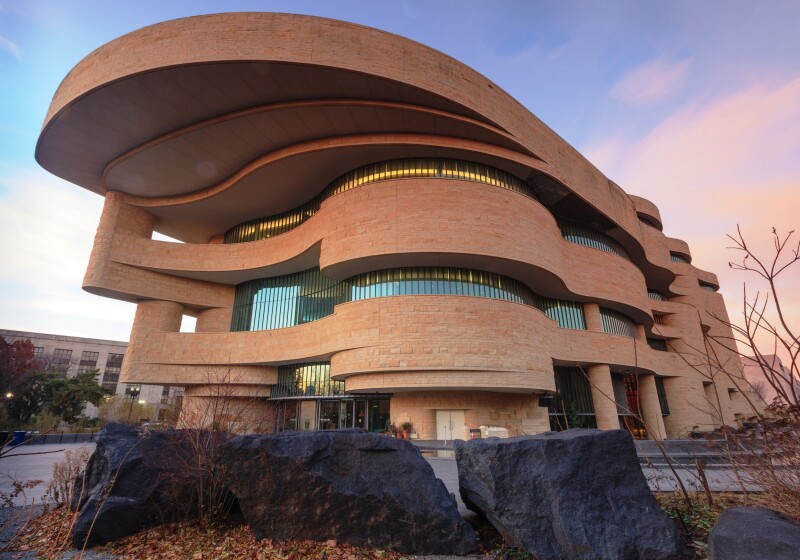 The curvilinear, terra-cotta colored exterior of the National Museum of the American Indian